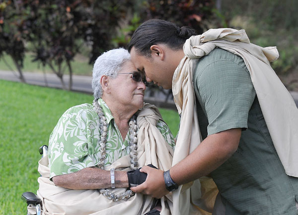Kahu Charles Kauluwehi Maxwell Sr. shares a meaningful moment with his grandson, Dane Kiyoshi Uluwehiokalani Maxwell, as he too becomes a kahu Sunday morning at Hale Makua.